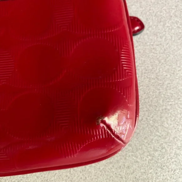 Coach Glossy Embossed Signature Wristlet
Cranberry Patent Leather Red - Picture 11 of 13